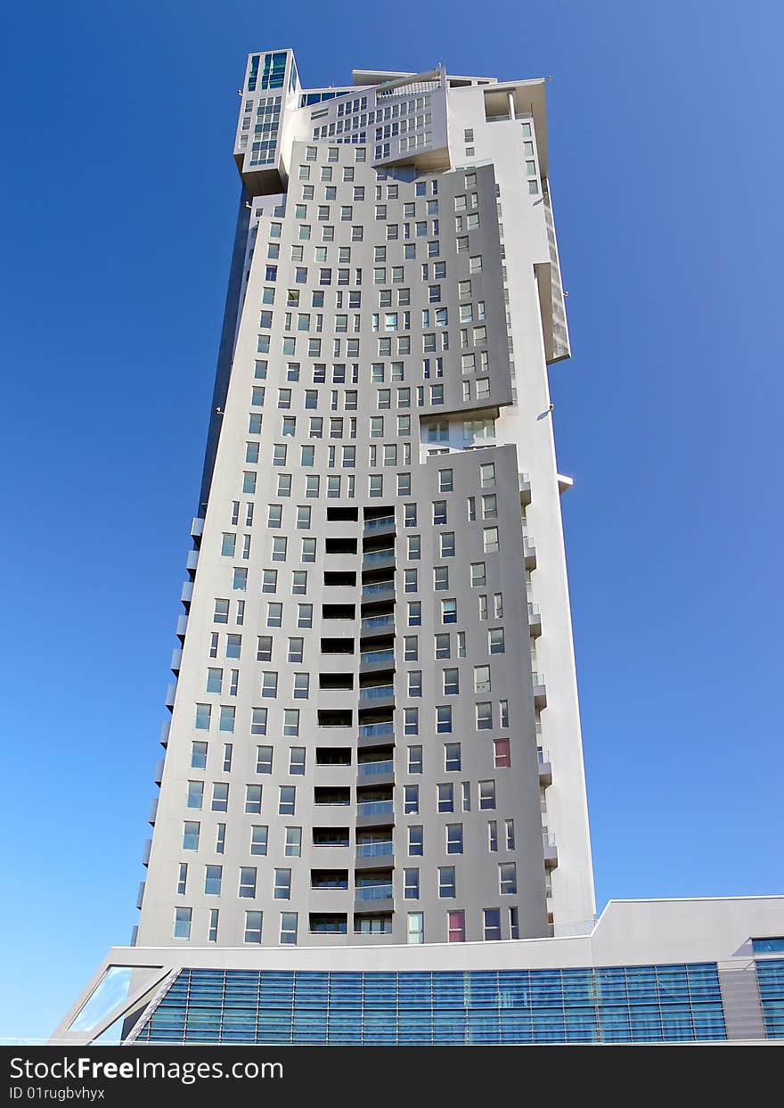 View on the new skyscraper on the blue sky from the street.