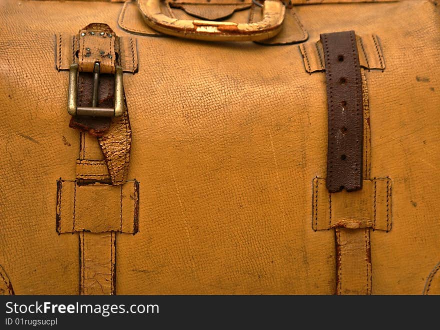 Close up detail of old lcracked eather suitcase with straps. Close up detail of old lcracked eather suitcase with straps.