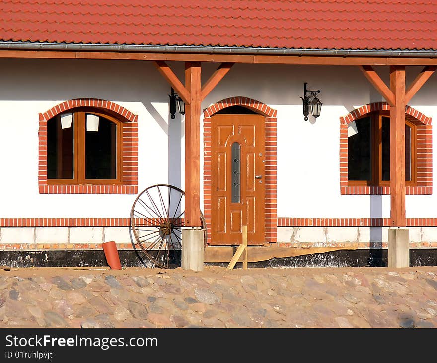 Close up of the front of the new farmhouse. View of the door to the new house in the countryside. Close up of the front of the new farmhouse. View of the door to the new house in the countryside.