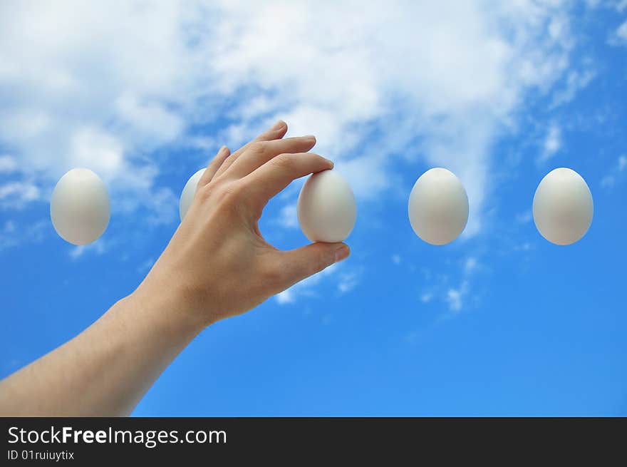 Egg in a hand against the blue sky. Egg in a hand against the blue sky