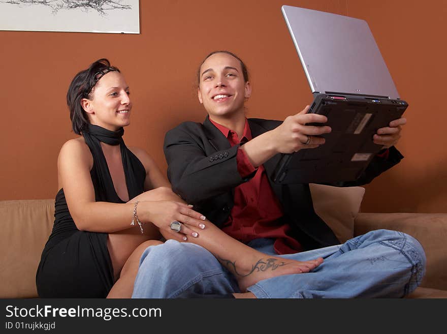 Young couple on the couch surfing the web with their laptop. Young couple on the couch surfing the web with their laptop.