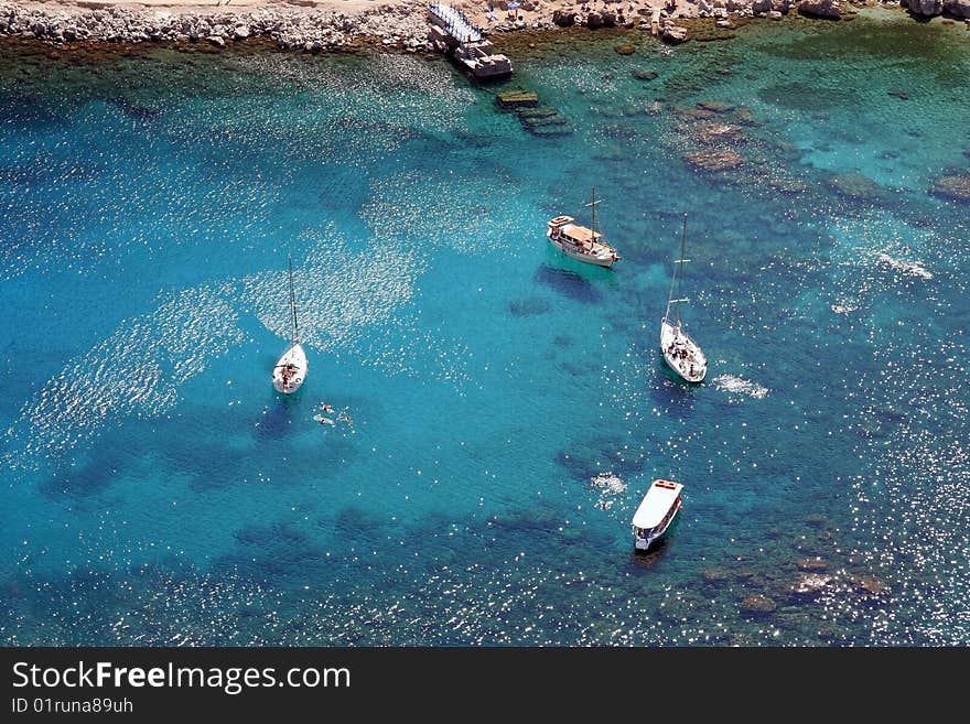 Some sailing ships in the amazing cyan colored ionian sea. Some sailing ships in the amazing cyan colored ionian sea.