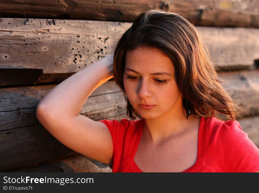 Nice girl in front of log house. Nice girl in front of log house