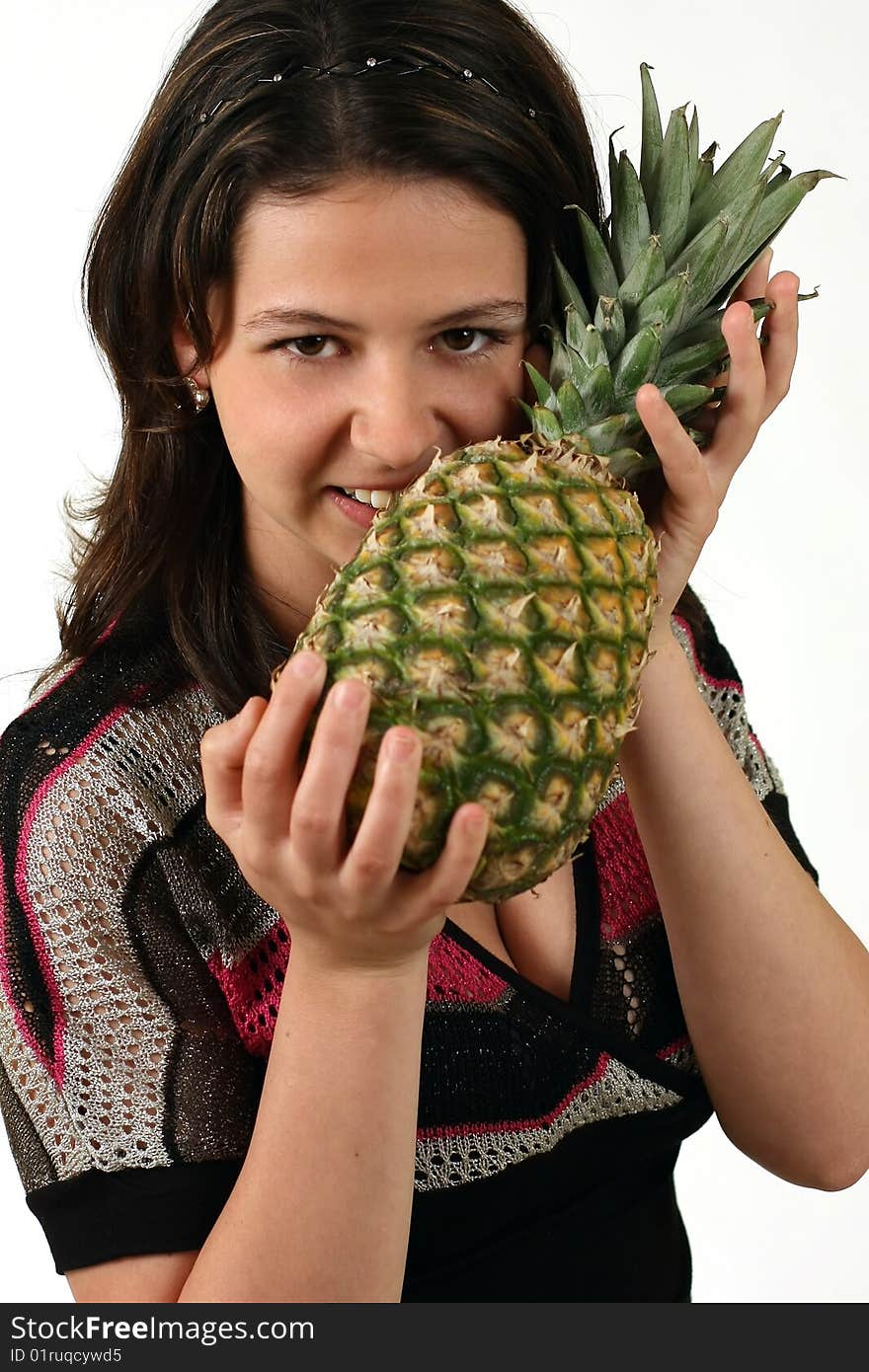 Smiling girl with pineapple on white background