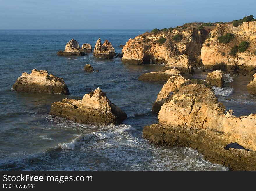 Algarve coast early morning.
Golden light bath the cliffs at low tide.