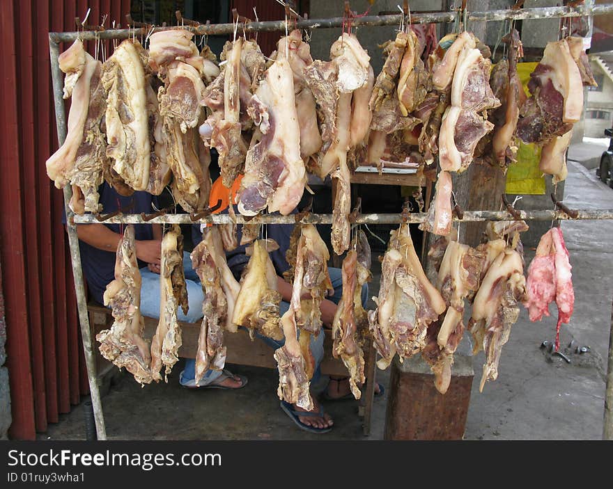 Typical butcher's stall with hanging lines of fat and lean meat. Philippines. Typical butcher's stall with hanging lines of fat and lean meat. Philippines