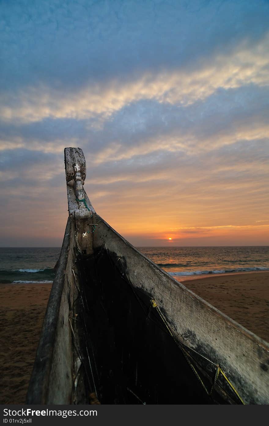 Fishing Boat on Beach at Sunset