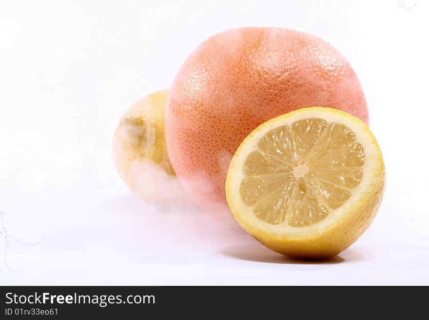 Orange and lemon in smoke that suggests freezing. Orange and lemon in smoke that suggests freezing