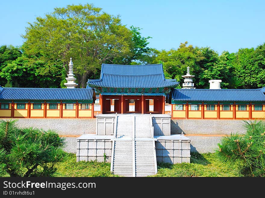 Front view of a model of temple architecture surrounded with nature. Front view of a model of temple architecture surrounded with nature