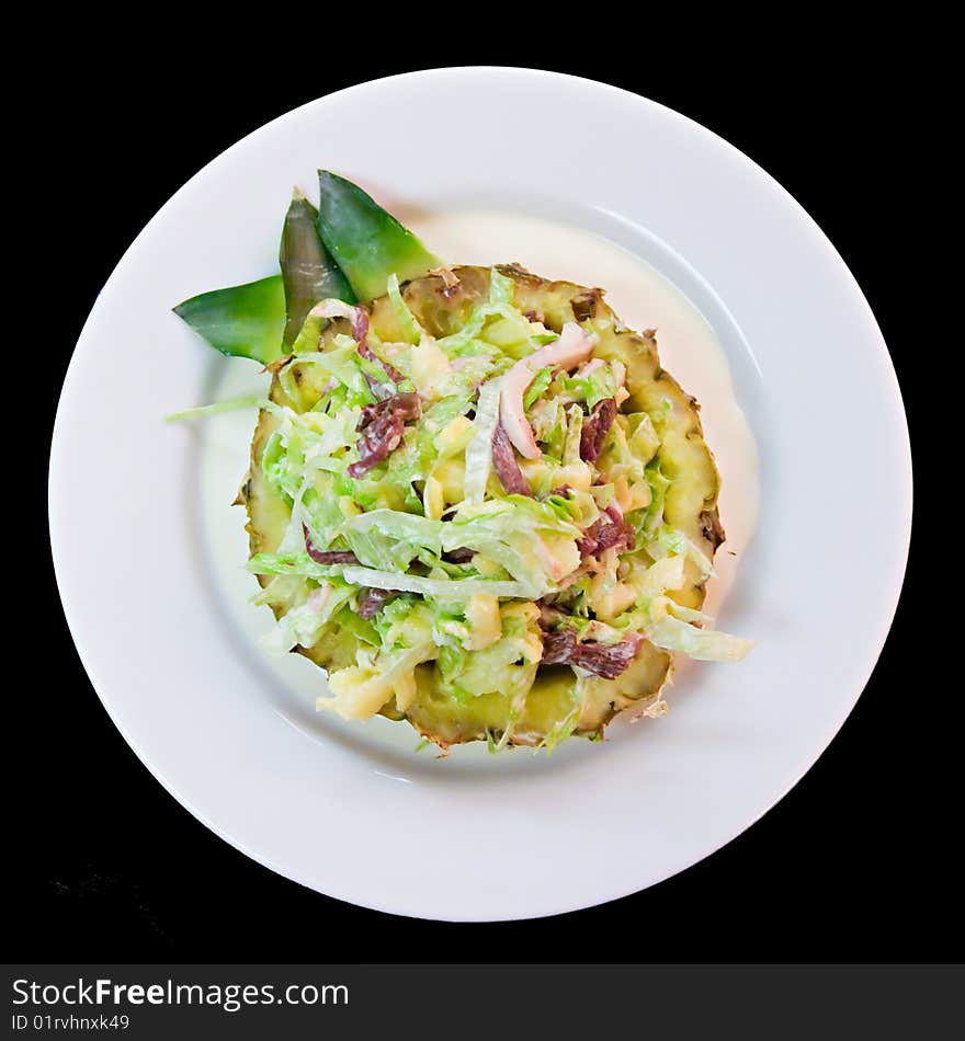 Salad with pineapple on a white plate