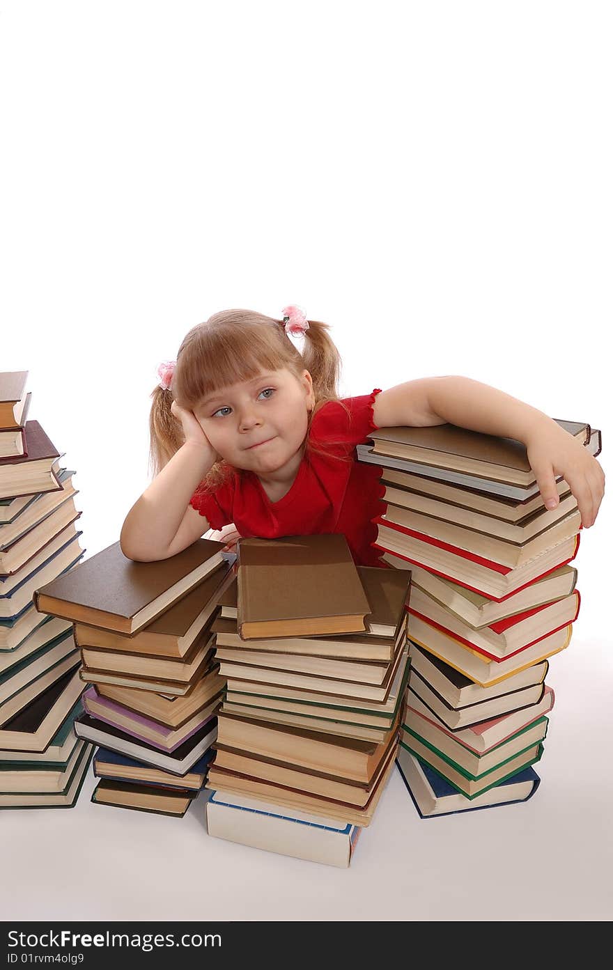 The dreaming little girl and books on a white background