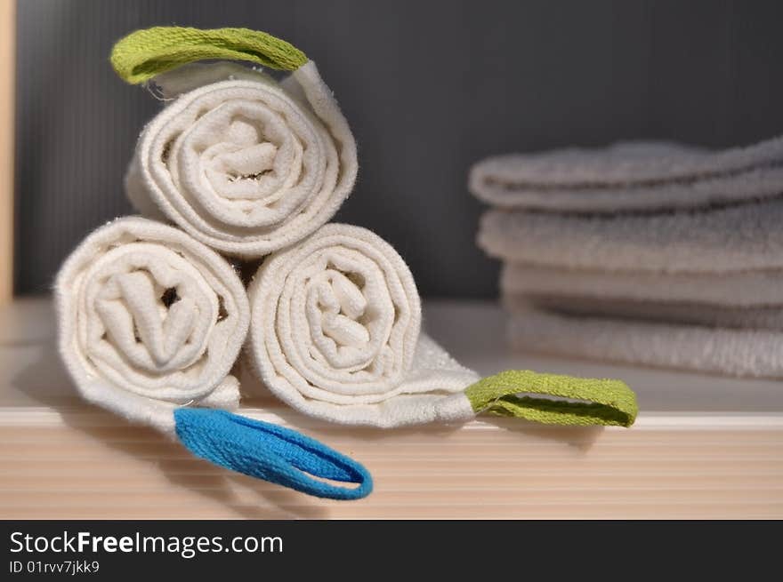 White rolled handtowels in a wardrobe. White rolled handtowels in a wardrobe