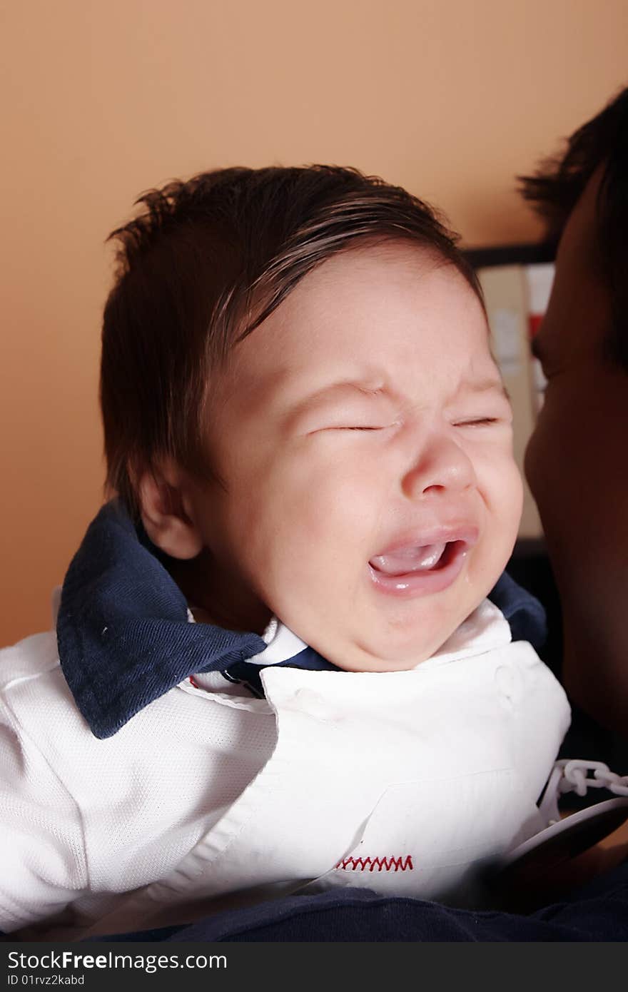 New born baby crying at father's shoulder. New born baby crying at father's shoulder