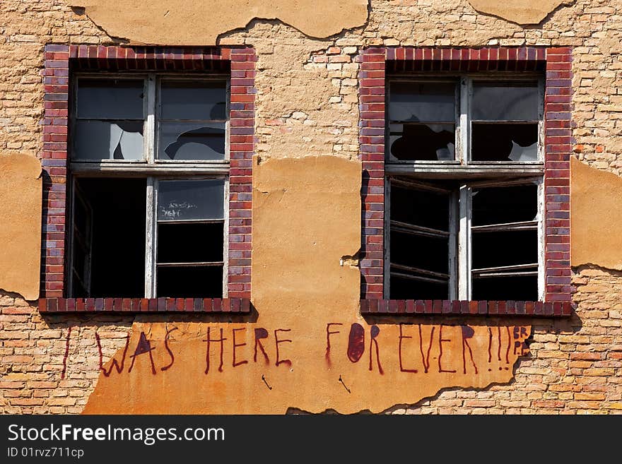 Old Brick Wall with Broken glass on the window