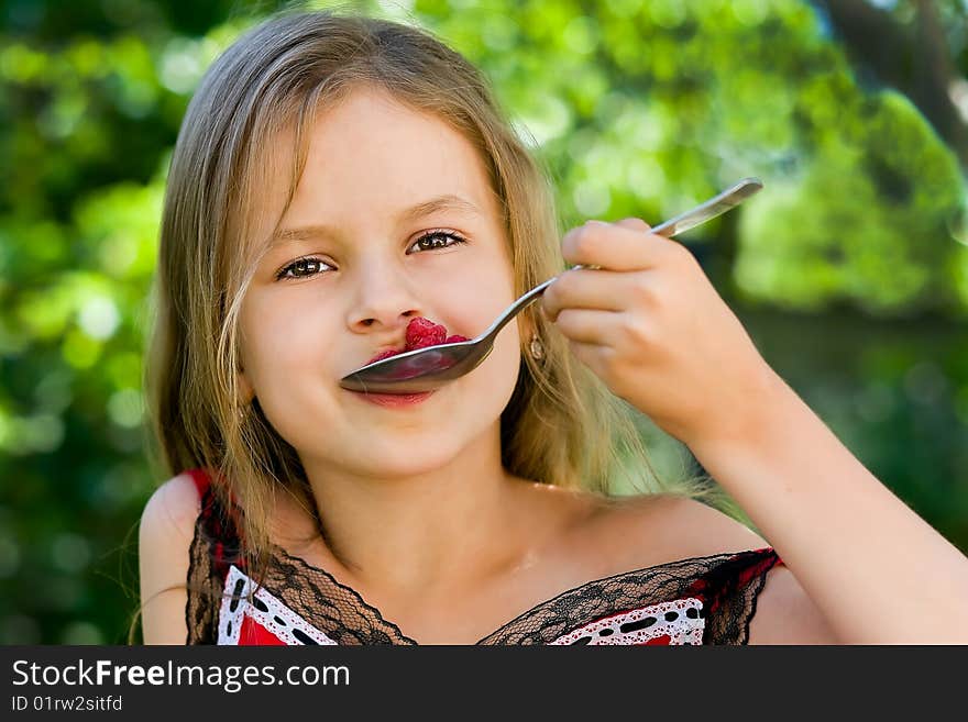 Girl eating raspberry