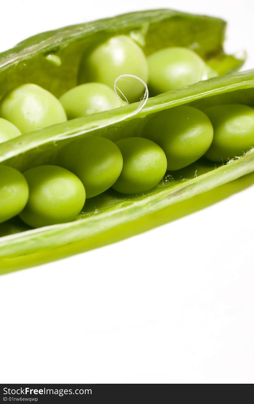 Fresh green peas isolated on white