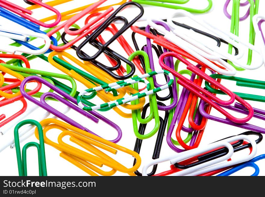 Color paper clips to background. Isolated on white