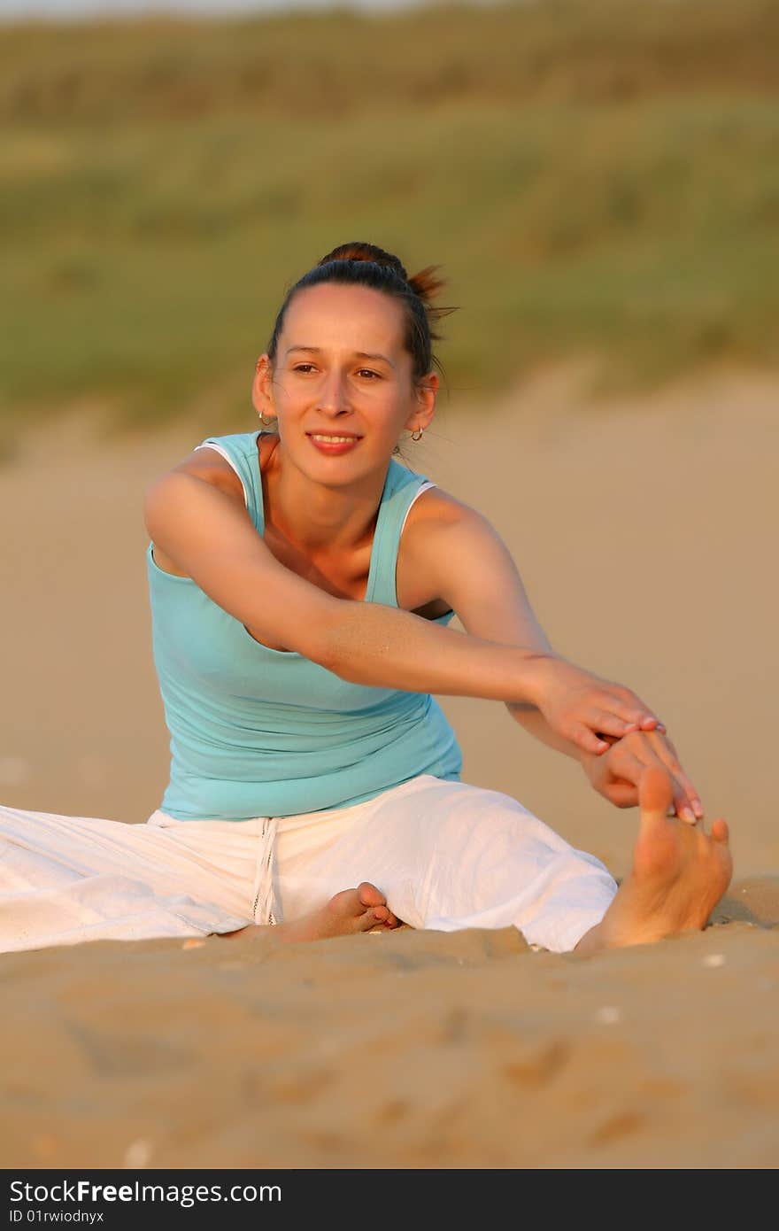 Woman doing fitness exercises at the beach. Woman doing fitness exercises at the beach