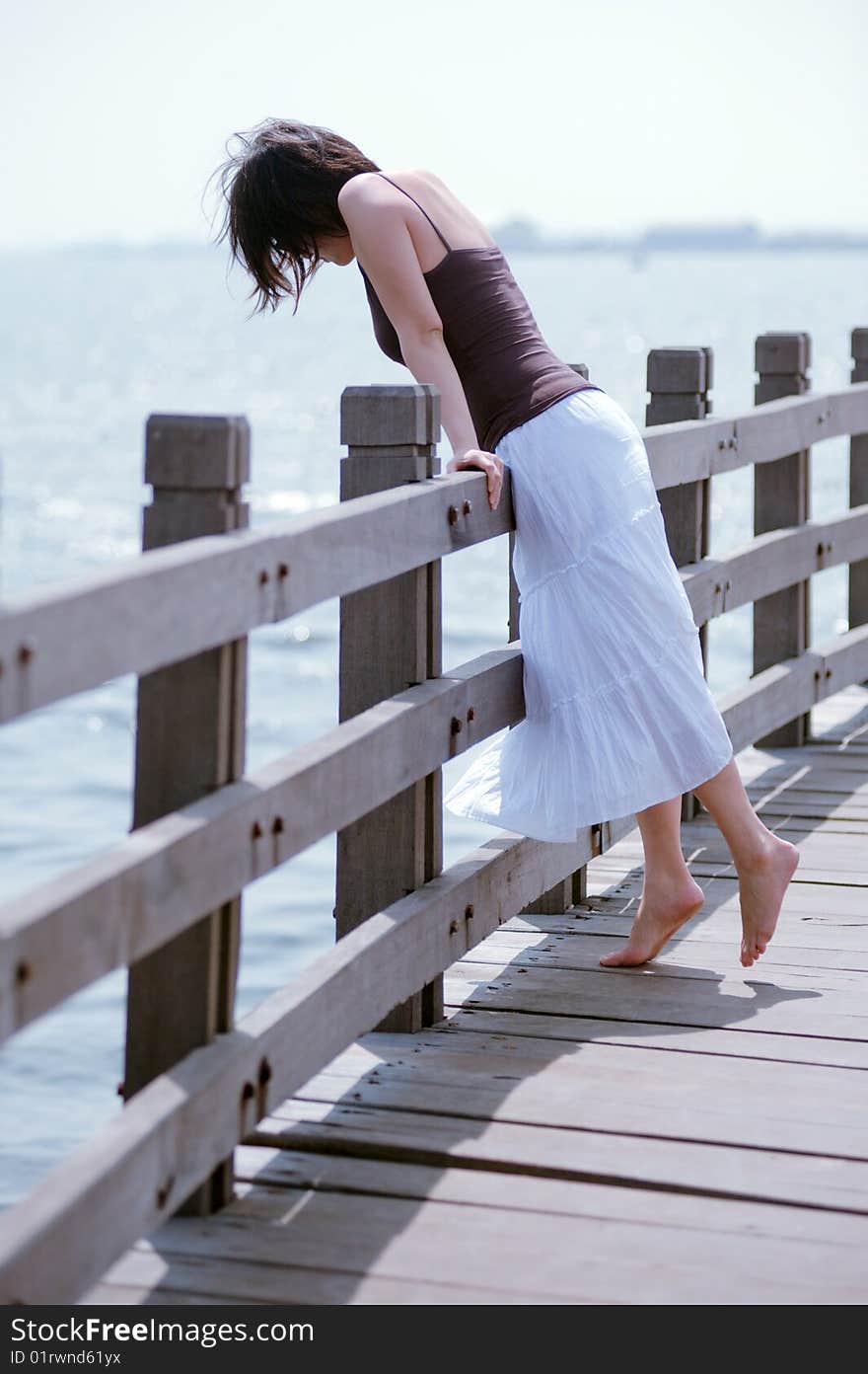 Girl Looks Over Railing