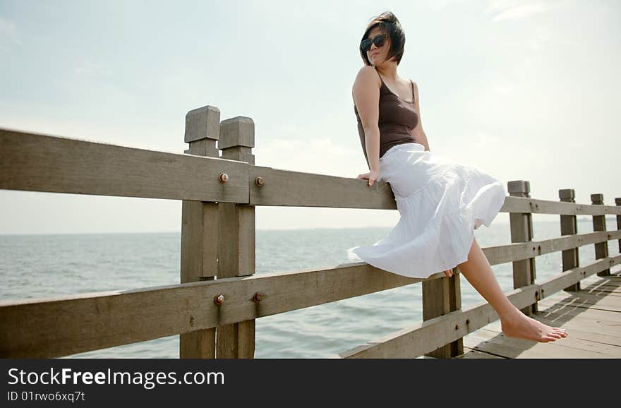 Girl sits on railing