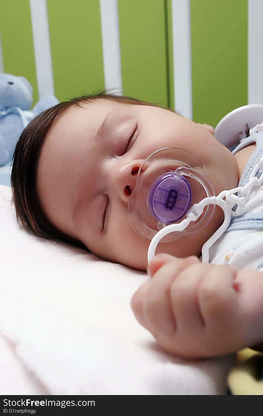 Newborn baby sleeping in bad with dummy. Newborn baby sleeping in bad with dummy