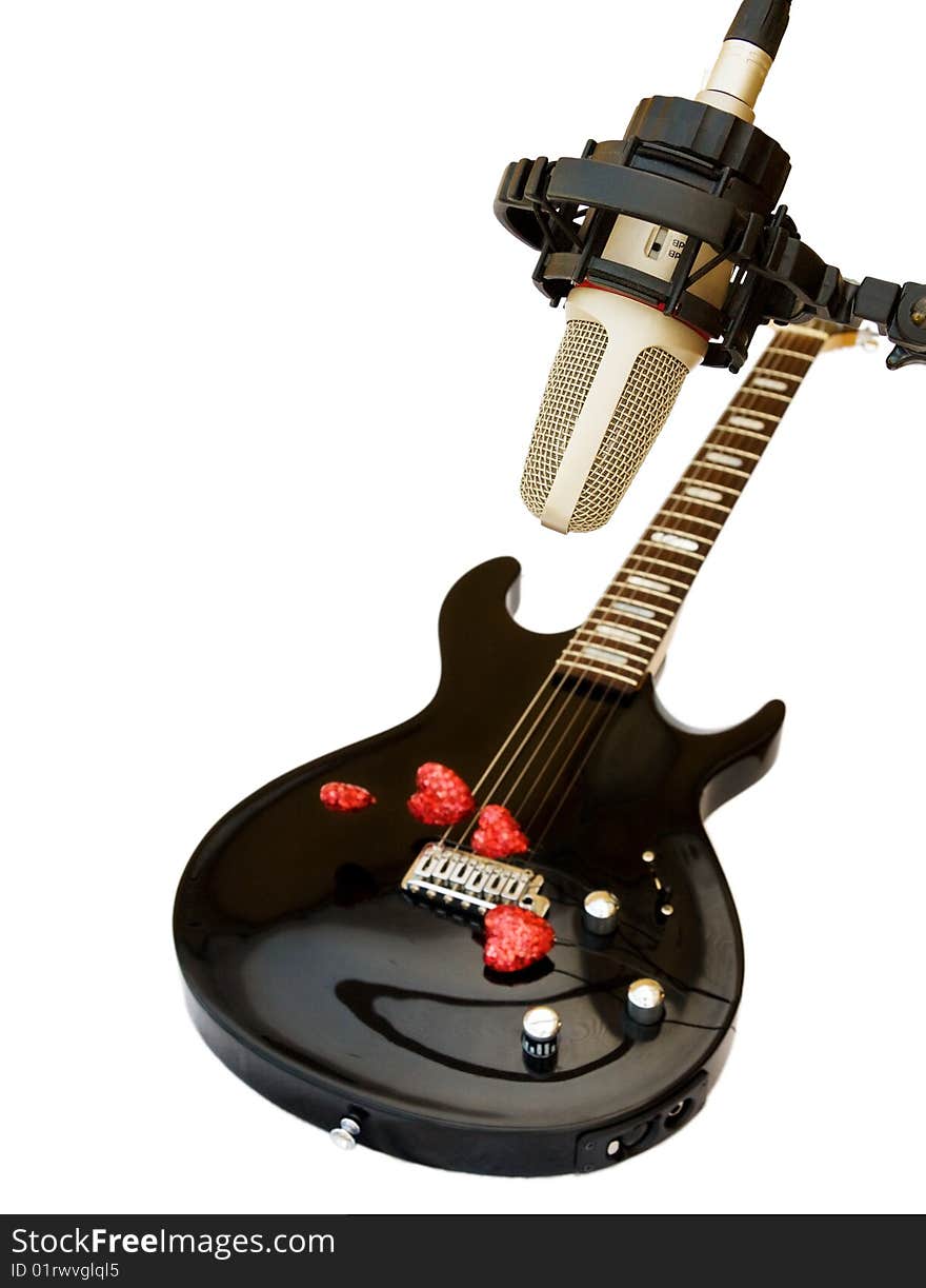 Song of Love - black electric guitar with recording studio microphone and red hearts. Isolated on white. Song of Love - black electric guitar with recording studio microphone and red hearts. Isolated on white.