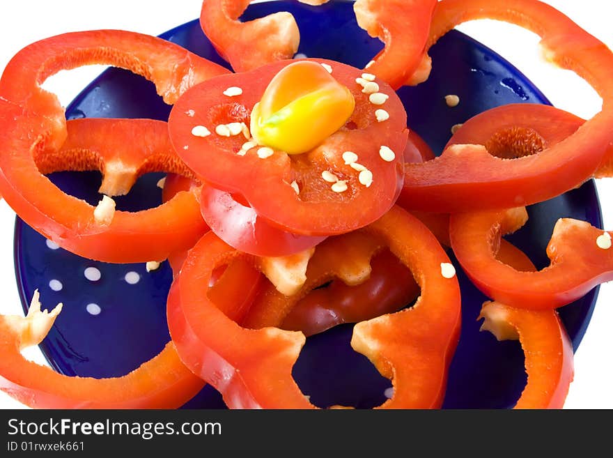 Sliced fresh red pepper on blue dish. Sliced fresh red pepper on blue dish