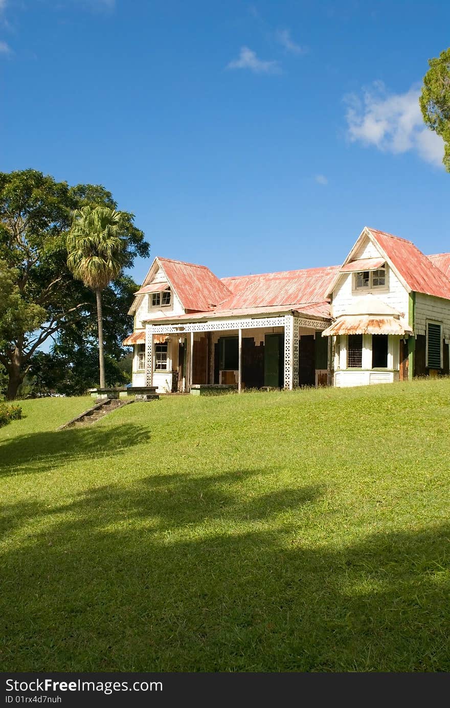 A house in a green garden on a sunny day. A house in a green garden on a sunny day.