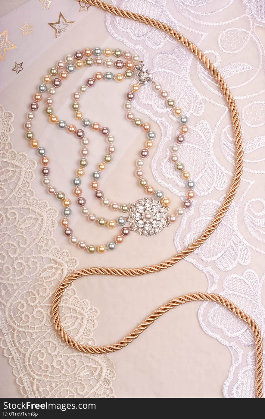 Chain and necklace on lace background. Chain and necklace on lace background