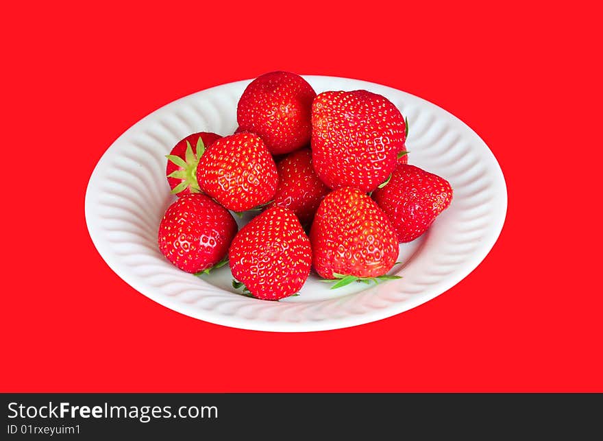 Strawberry in a plate over a red background