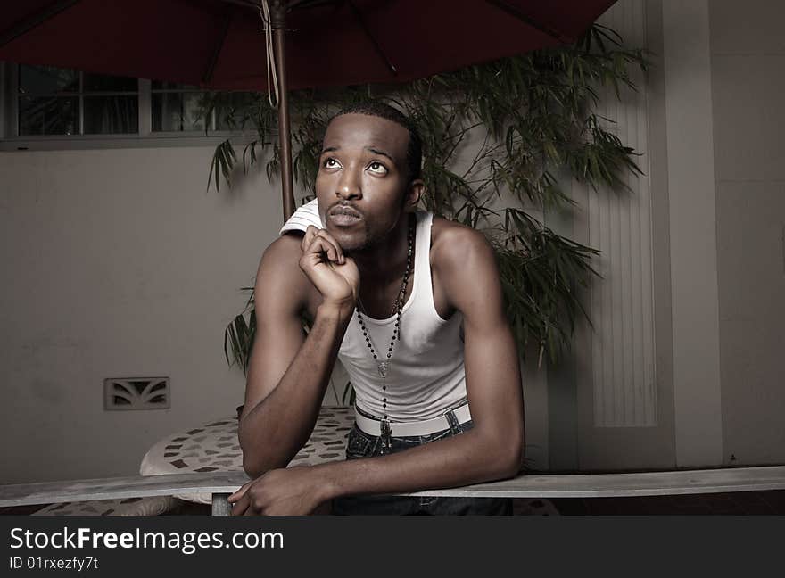 Young man leaning on a rail and thinking about something. Young man leaning on a rail and thinking about something