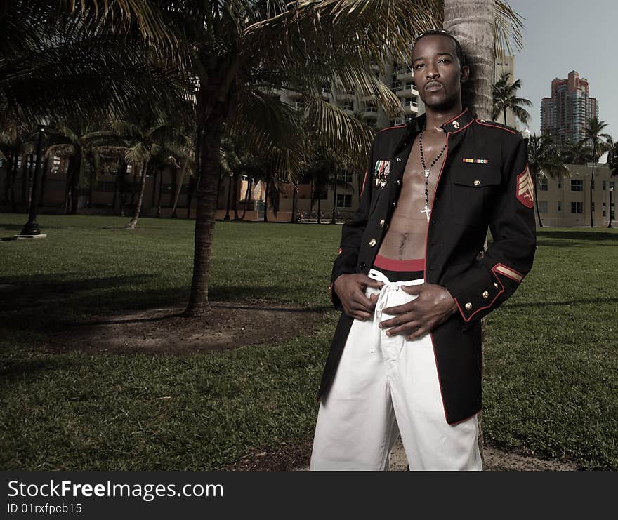 Male model posing in military clothing in the park. Male model posing in military clothing in the park