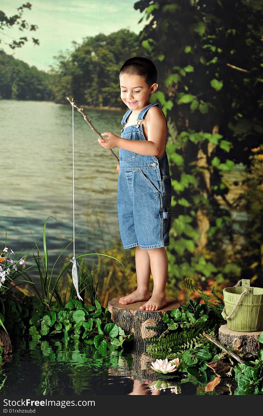 A young, barefoot boy delighted when catching his first fish.