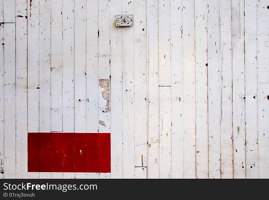 A very simple photo of a white wall with lines in the paint and a red rectangle of color. A very simple photo of a white wall with lines in the paint and a red rectangle of color.