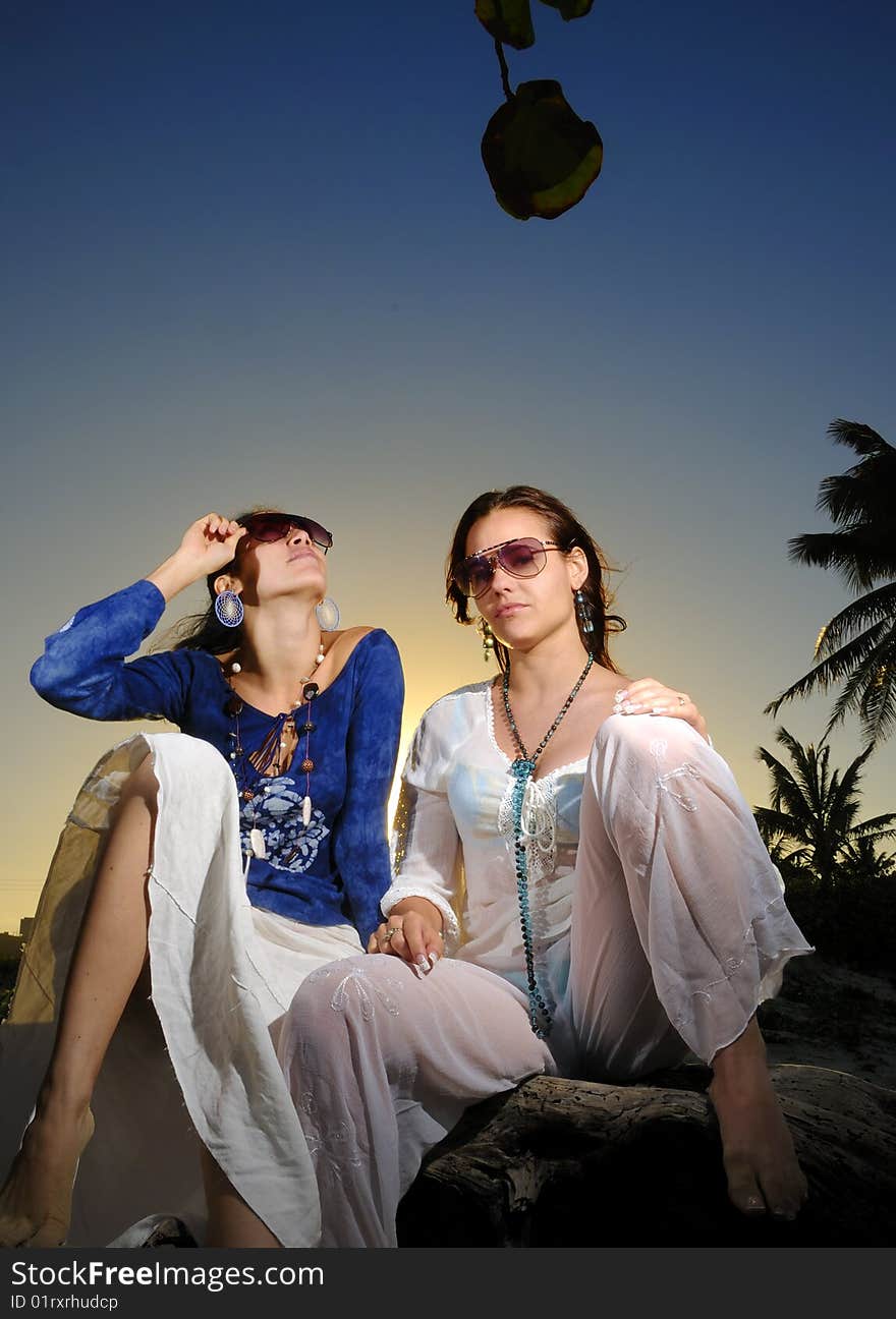 Portrait of two trendy young women on tropical sunset. Portrait of two trendy young women on tropical sunset