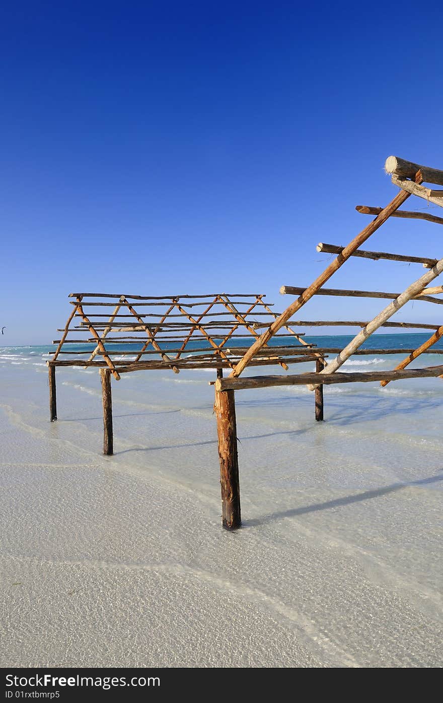 A view of tropical beach with wooden structure, cayo coco, cuba. A view of tropical beach with wooden structure, cayo coco, cuba