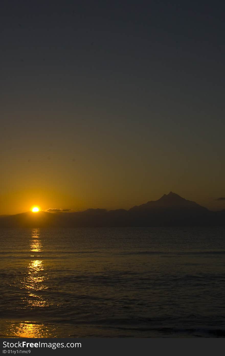 Sunrise and the mountain Athos