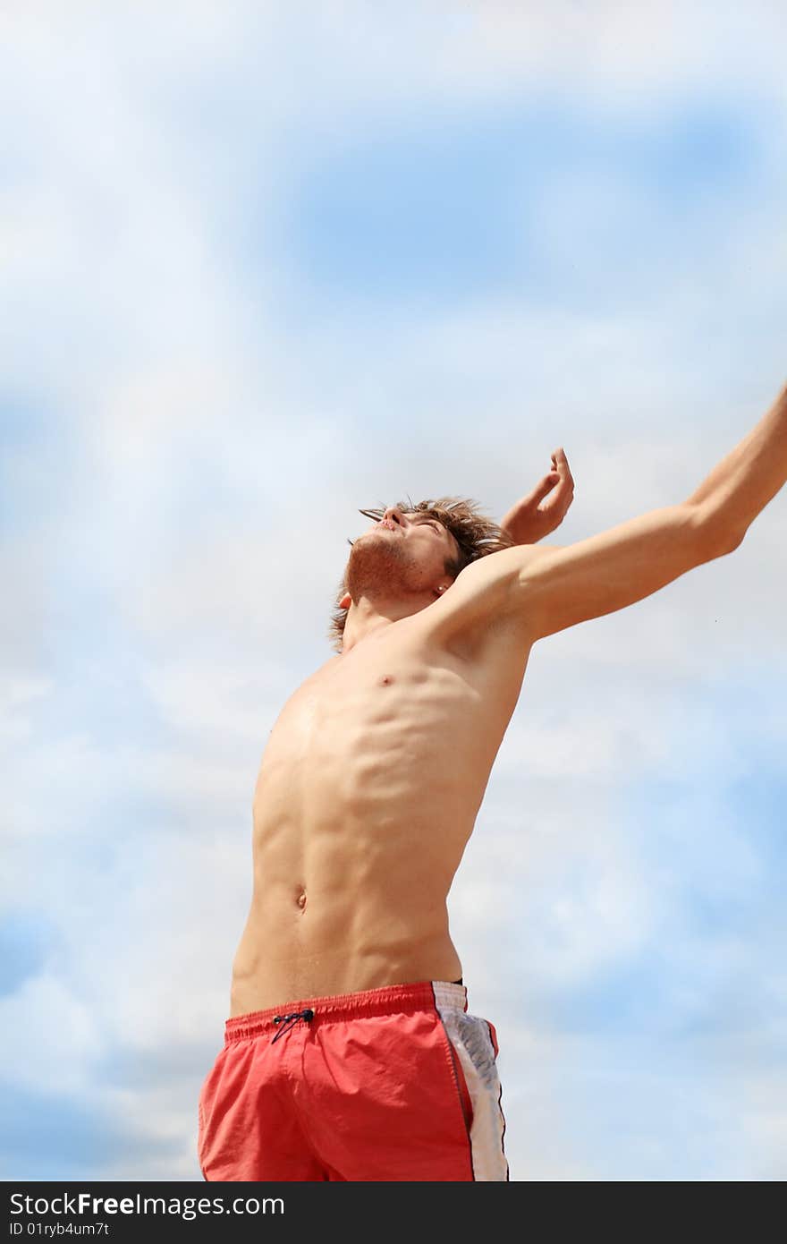 Portrait of a young man playing volleyball on a beach. Portrait of a young man playing volleyball on a beach.