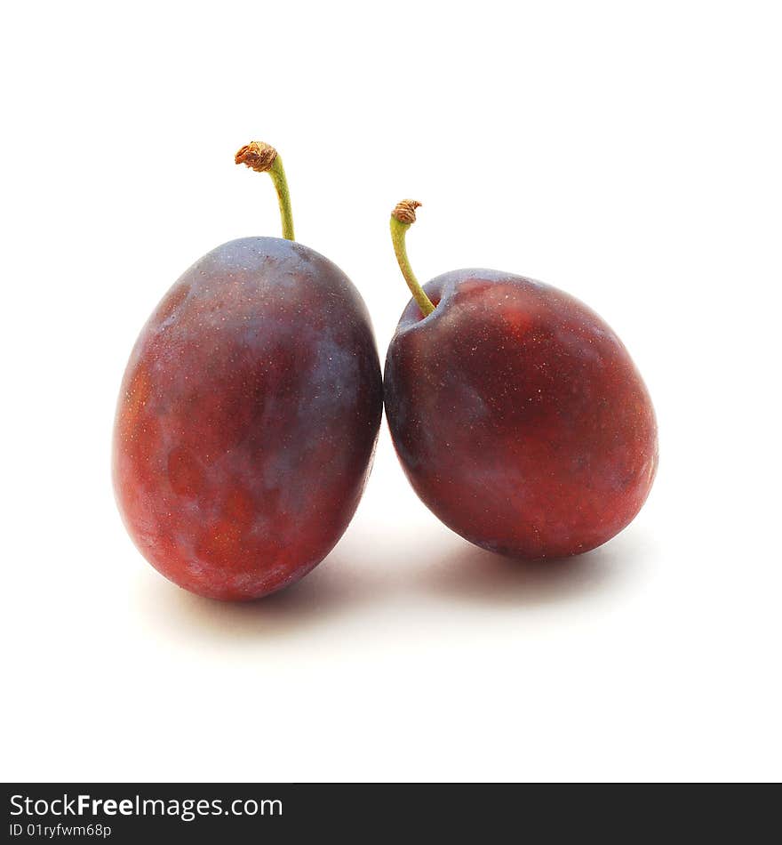 Two plums isolated on white background