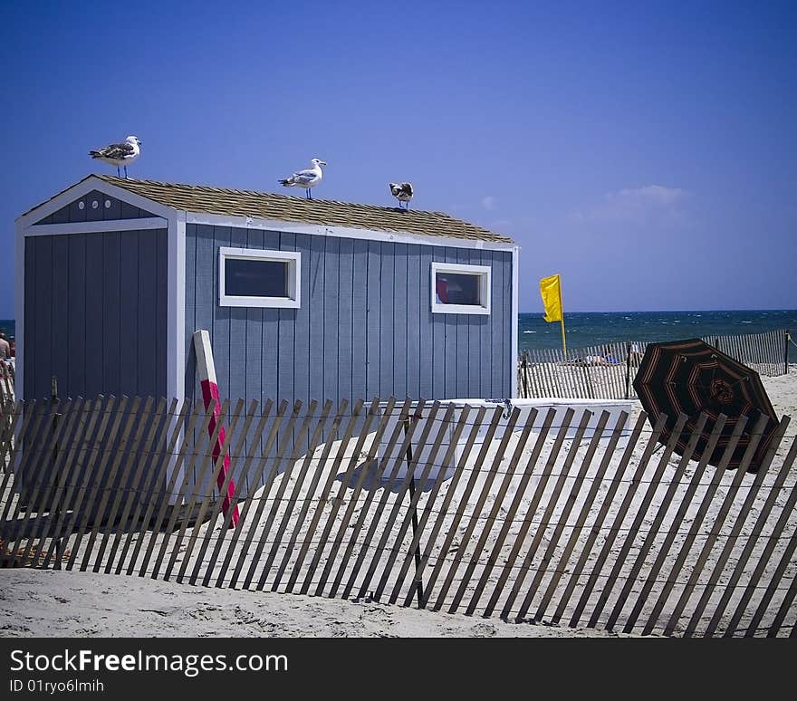 A shuttered up shack sits on a beach. A shuttered up shack sits on a beach