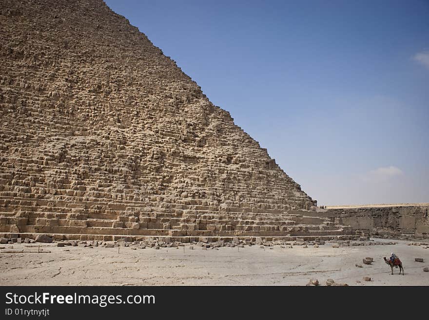 The Pyramid of Khafrae is the second largest of the Ancient Egyptian Pyramids of Giza and the tomb of the fourth-dynasty pharaoh Khafre (Chephren in Greek), The pyramid has a base length of 215.25 m (706 ft) and originally rises to a height of 143.5 m (471 ft). The Pyramid is made of Limestone blocks (weighing more than 2 tons each). The slope of the pyramid rises at an 53� 10' angle, steeper than