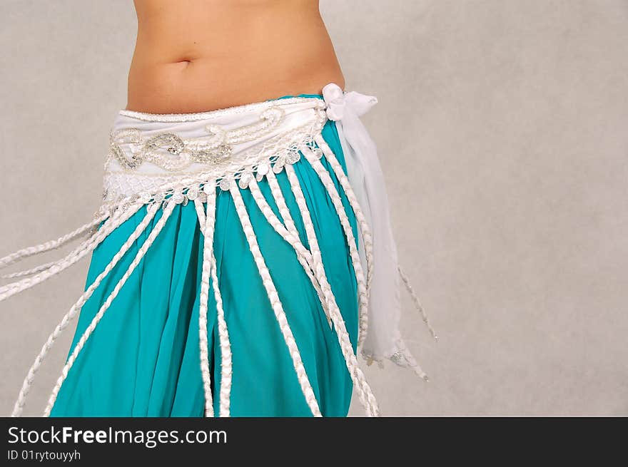 Belly-dancer in traditional turquoise blue attire. Belly-dancer in traditional turquoise blue attire