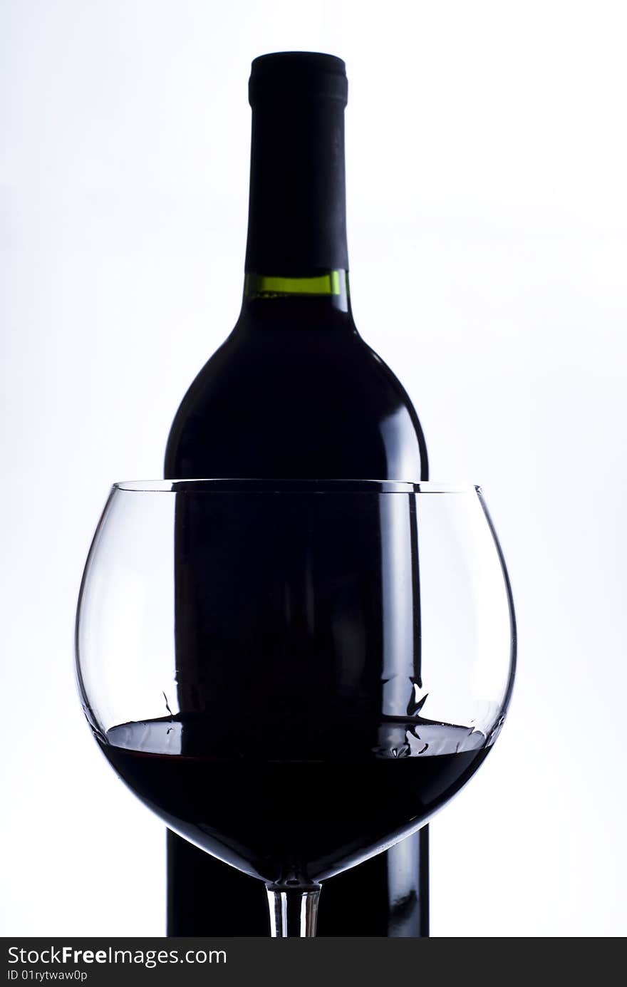 Glass with red wine and bottle of red wine. Glass with red wine and bottle of red wine