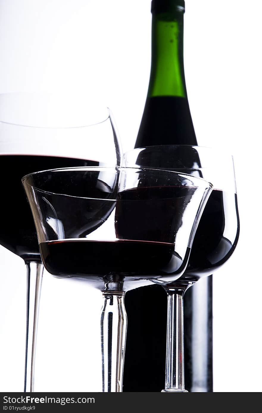 Three glasses with red wine and bottle