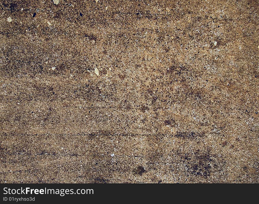 This is a close up photo of a dirty section of concrete. This is a close up photo of a dirty section of concrete