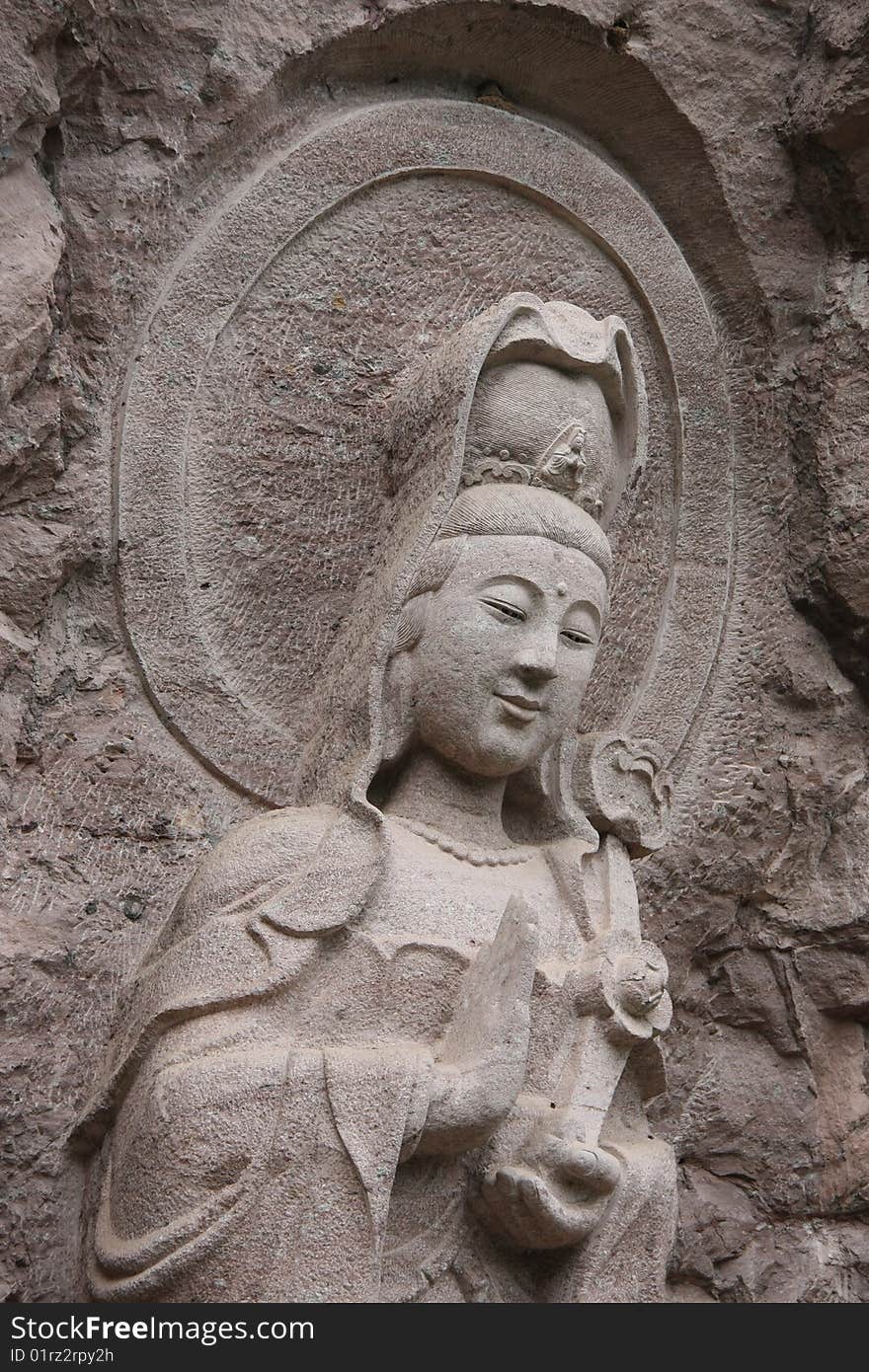 It's a KWAN-YIN stone carving in Wuyi Mountain,Fujian Province,China.
It means peace and heathy.