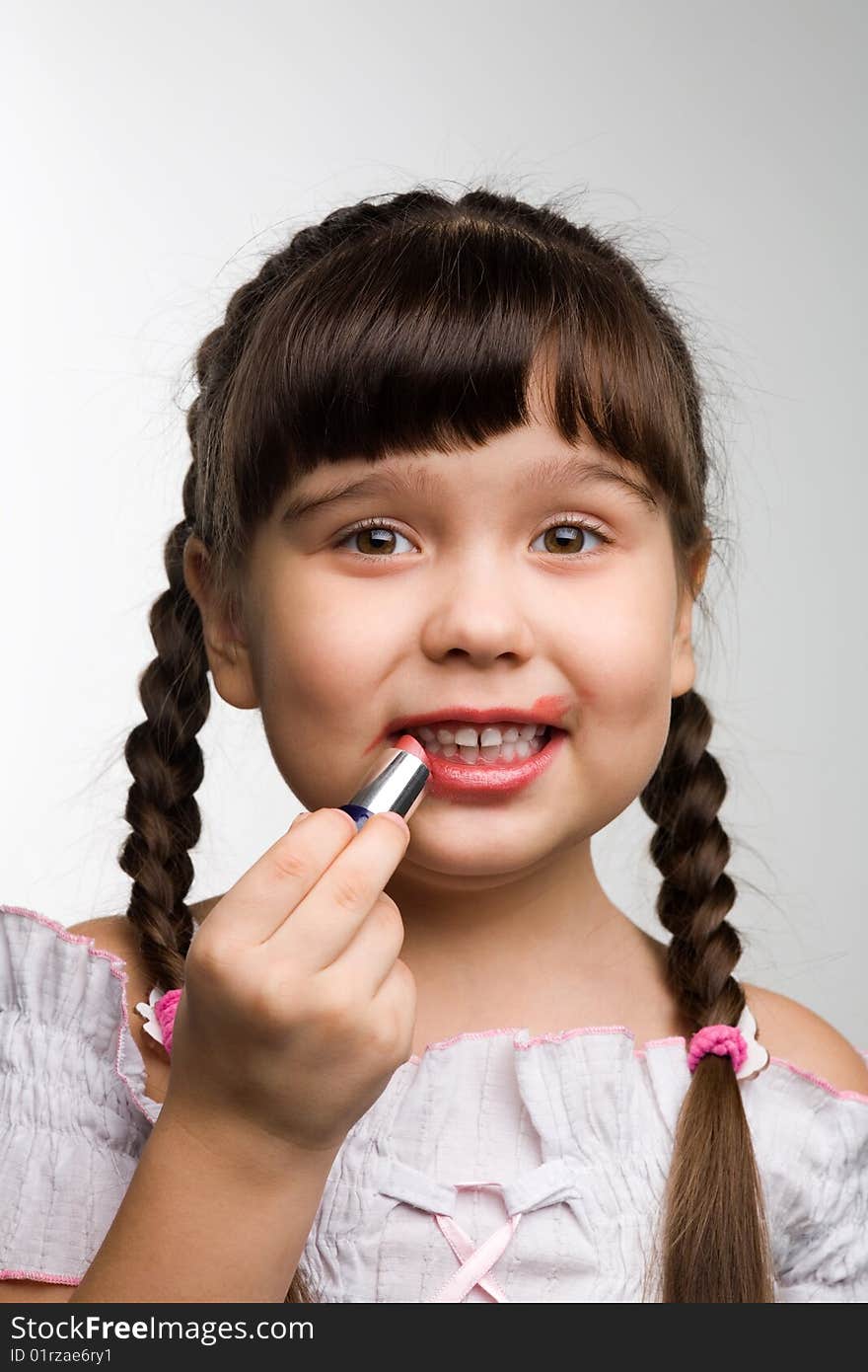 Photo of a girl with lipstick, playing adult. Photo of a girl with lipstick, playing adult