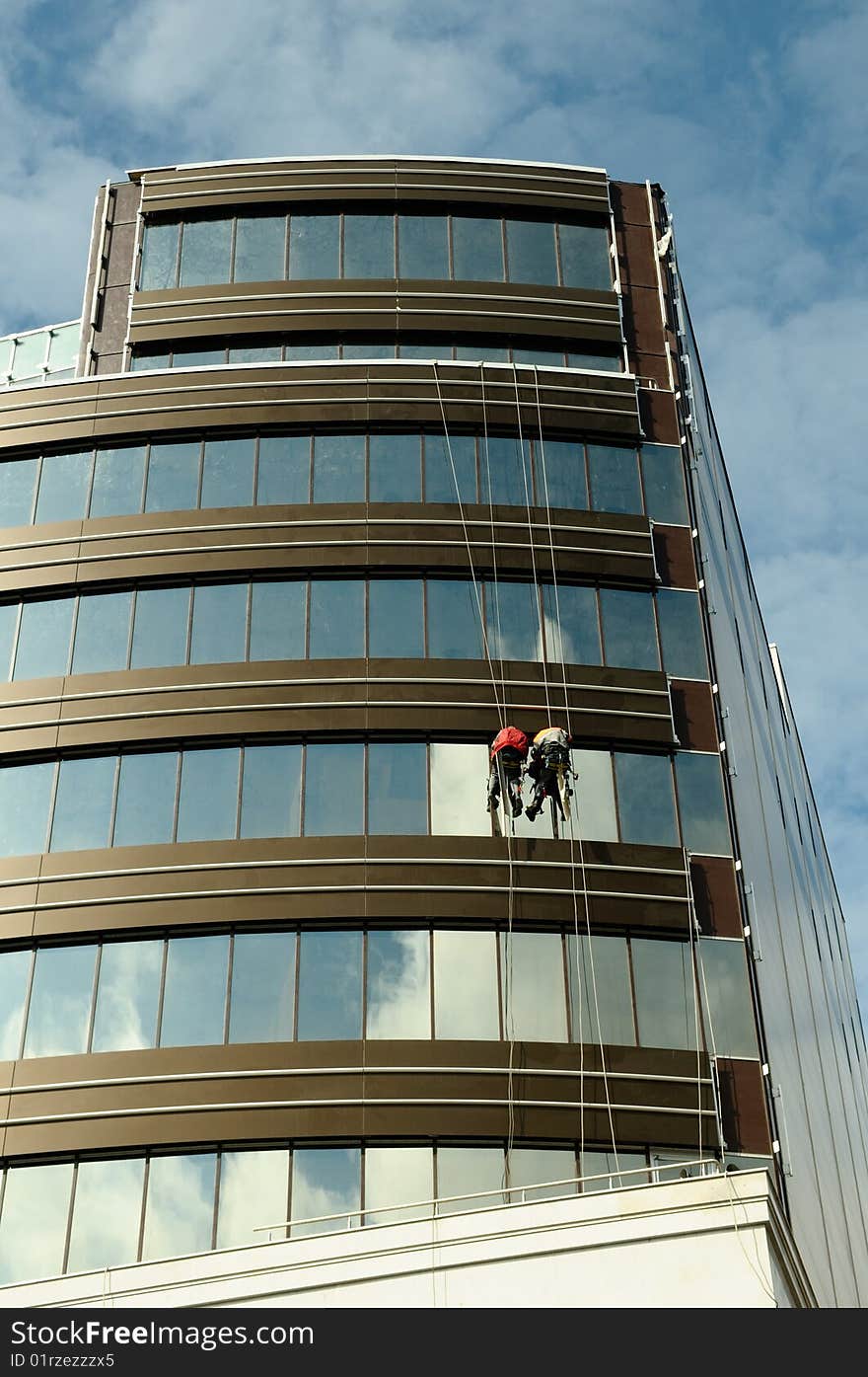 Steeplejacks work at construction of office building. Steeplejacks work at construction of office building.