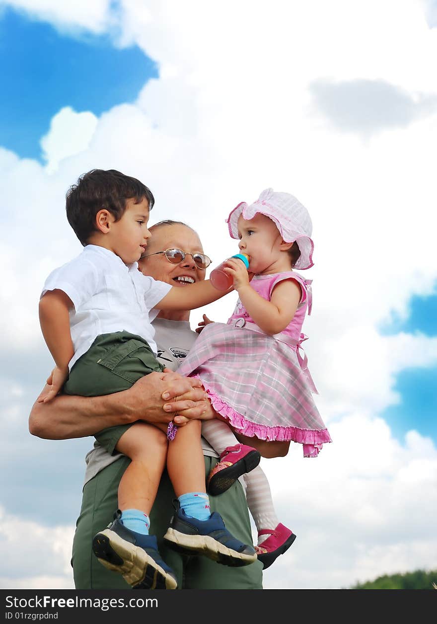 Grandmother And Kids In Her Armful