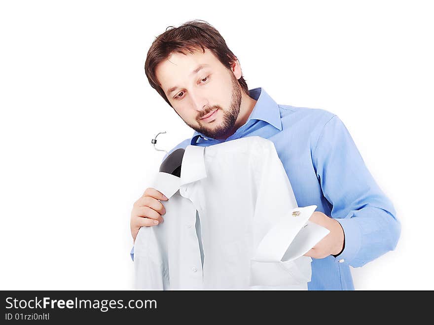 Man is holding two shirts and choosing to wear. Man is holding two shirts and choosing to wear